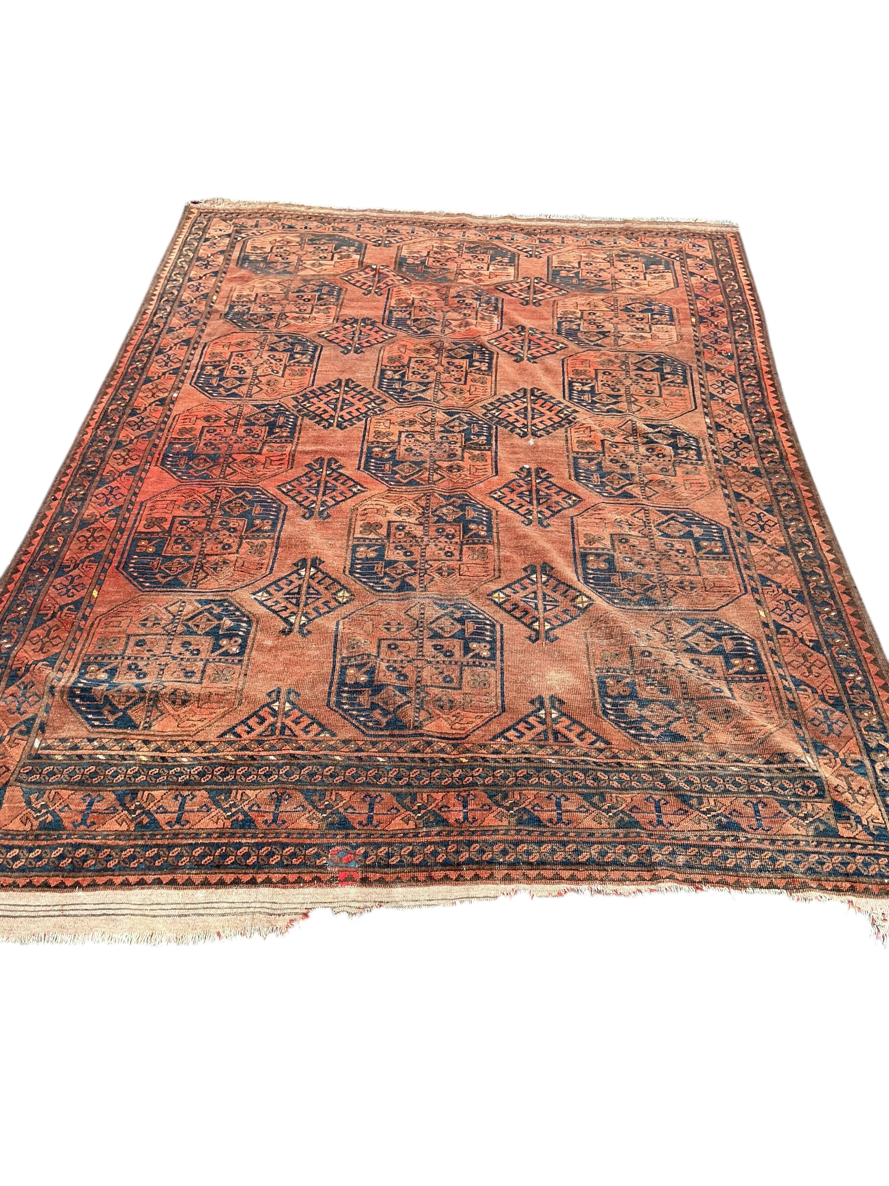 An Afghan brick red ground carpet, 285 x 210cm